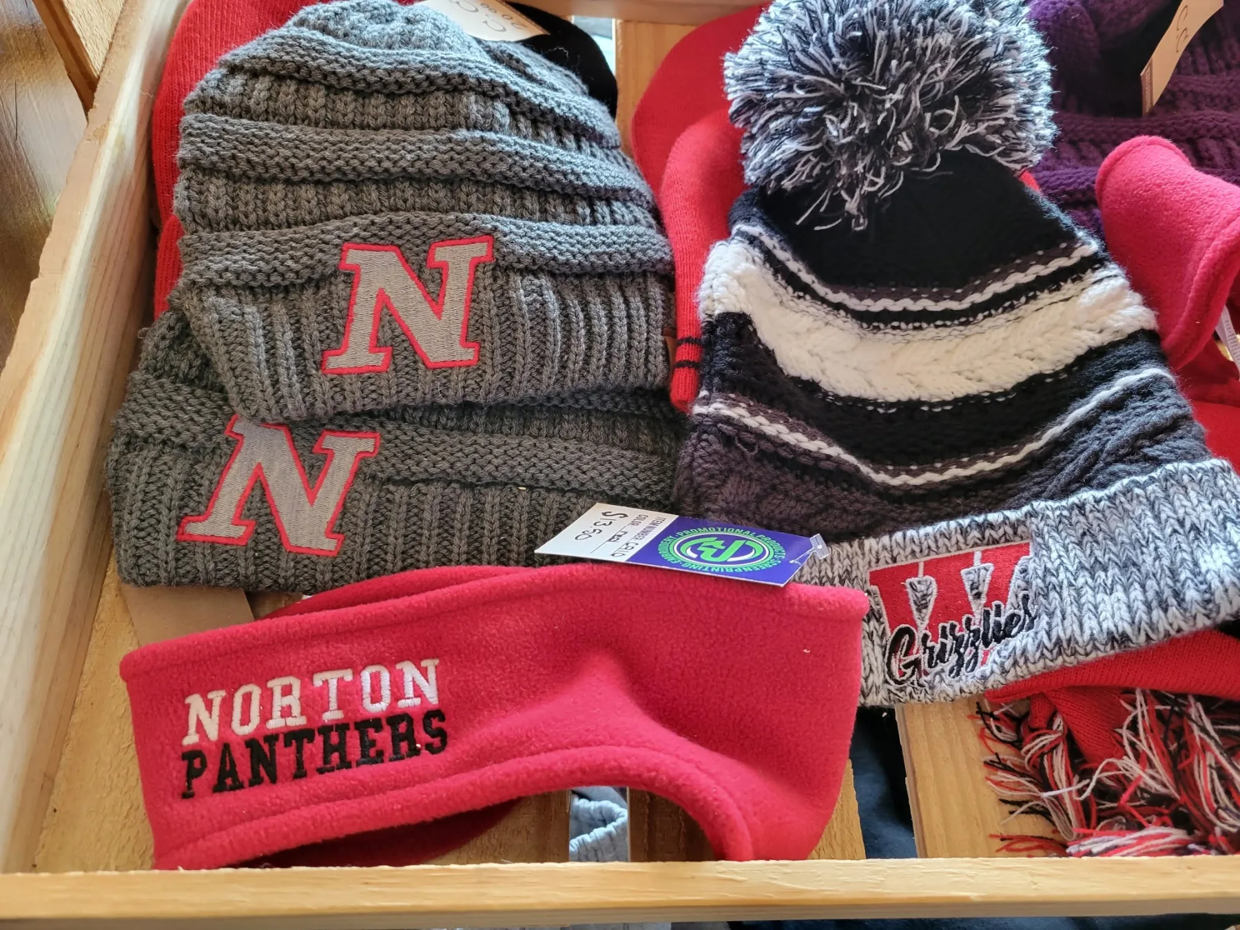 A cluster of custom embroidered school spiritwear made at Rylon Printing