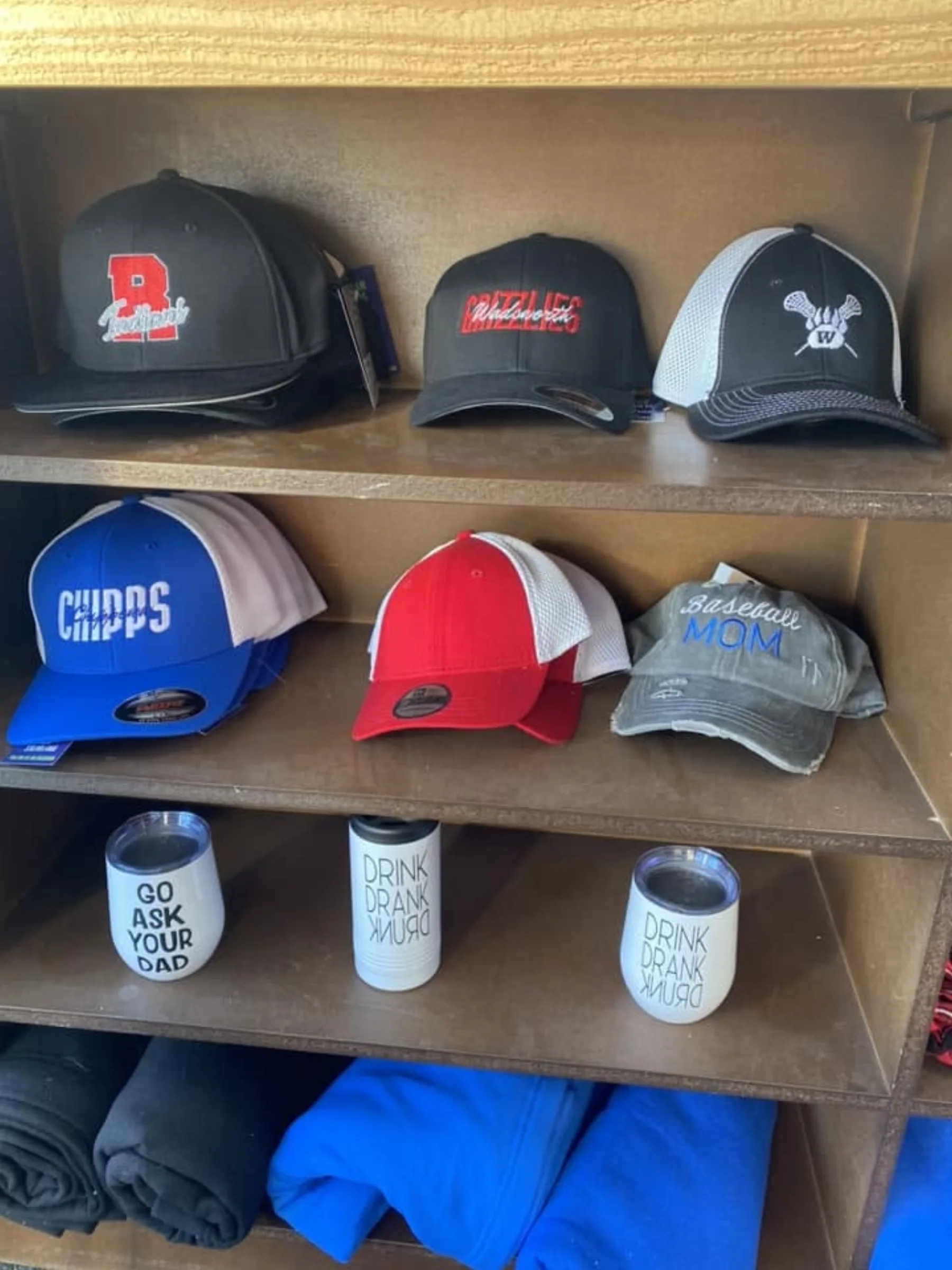 Shelf of custom embroidered team caps